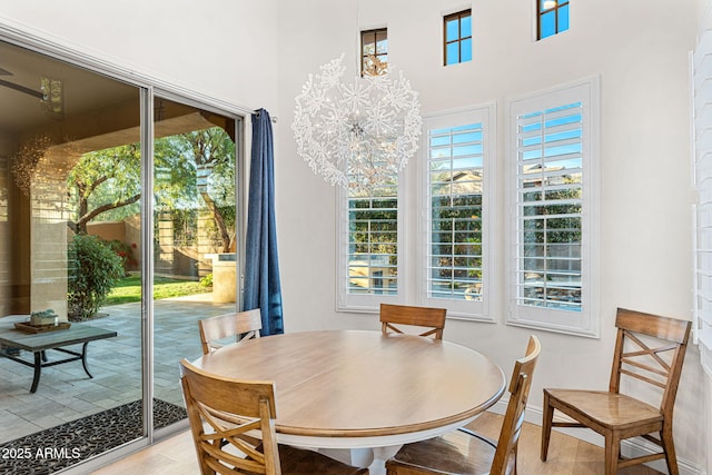 dining space featuring light hardwood / wood-style floors and a notable chandelier