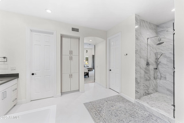 bathroom featuring vanity and a tile shower