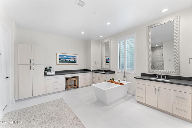 bathroom with vanity and shower with separate bathtub