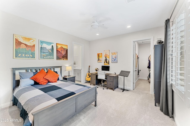 carpeted bedroom featuring a spacious closet, ceiling fan, and ensuite bathroom