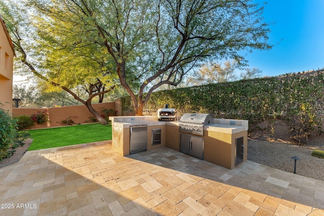 view of patio featuring exterior kitchen and grilling area