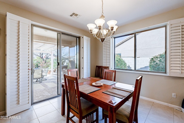 tiled dining area with an inviting chandelier