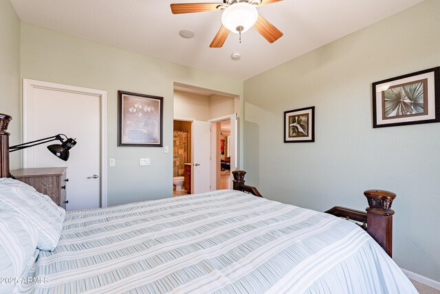 bedroom with ensuite bath and ceiling fan