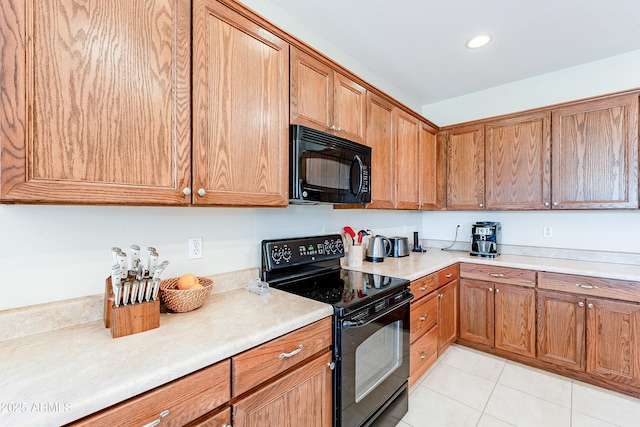 kitchen featuring light tile patterned floors and black appliances