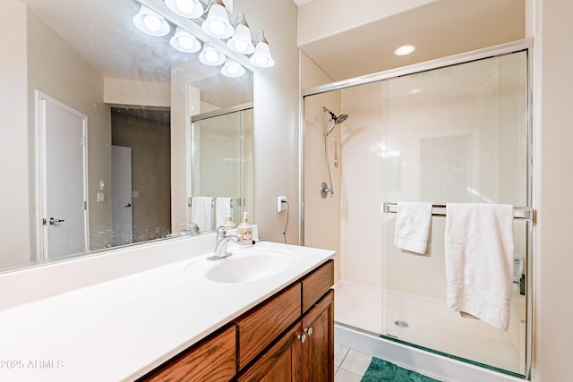 bathroom with tile patterned floors, vanity, and a shower with shower door