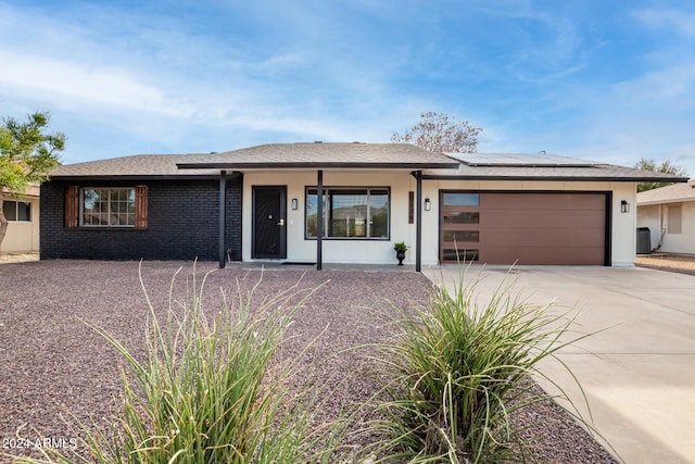 view of front of property with a garage and central AC unit