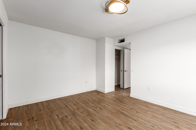 spare room with hardwood / wood-style floors