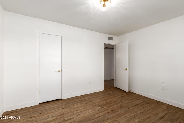 unfurnished bedroom with dark wood-type flooring