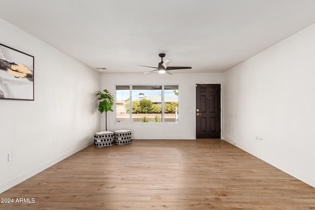 unfurnished room featuring light wood-type flooring and ceiling fan