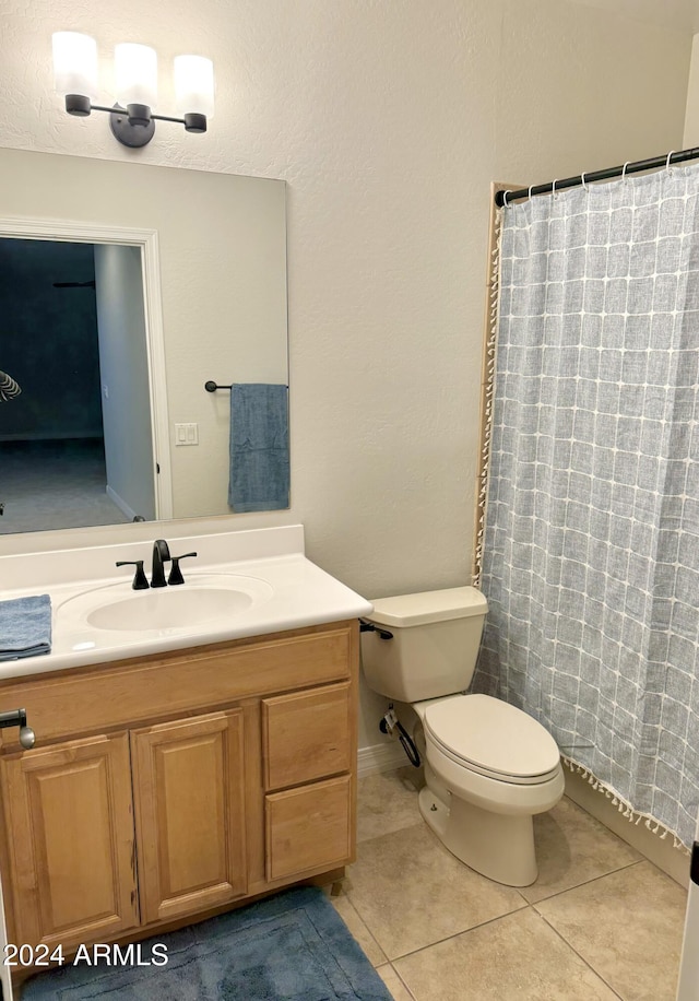 bathroom featuring vanity, tile patterned flooring, and toilet