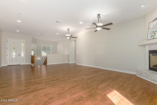 unfurnished living room featuring wood-type flooring and ceiling fan