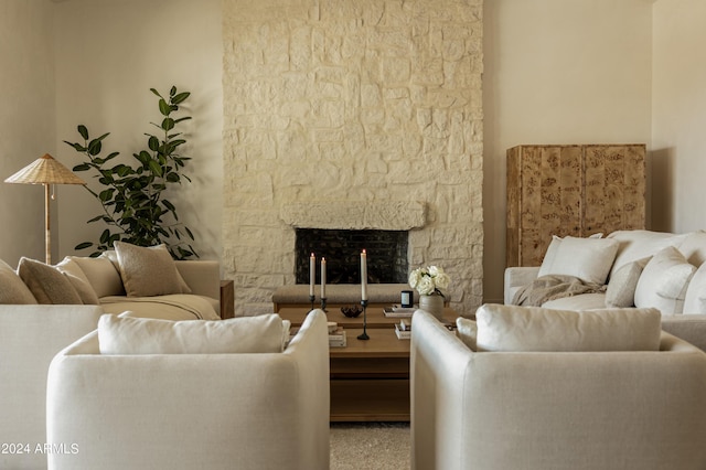 living room featuring a stone fireplace