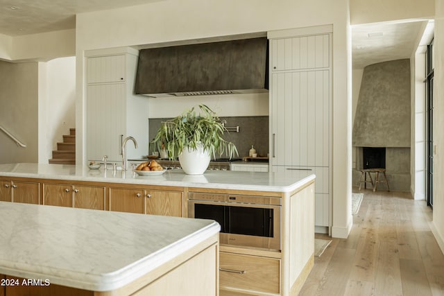 kitchen with a center island, sink, and light hardwood / wood-style flooring