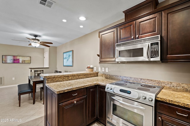 4200 N Miller Rd Unit 408, Scottsdale, AZ 85251 - kitchen with stainless steel appliances, a peninsula, ceiling fan, dark brown cabinetry, and recessed lighting