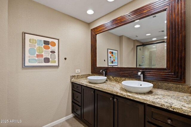 4200 N Miller Rd Unit 408, Scottsdale, AZ 85251 - full bathroom featuring double vanity, an enclosed shower, a textured wall, and recessed lighting
