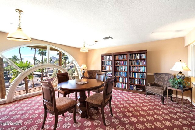 4200 N Miller Rd Unit 408, Scottsdale, AZ 85251 - carpeted dining area with a textured ceiling