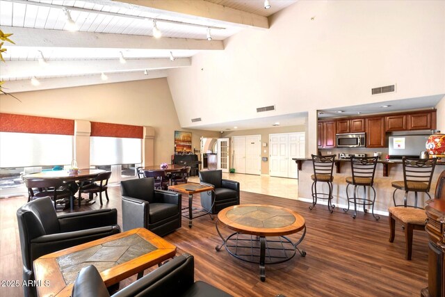 4200 N Miller Rd Unit 408, Scottsdale, AZ 85251 - living room with high vaulted ceiling, dark wood-style floors, track lighting, and beamed ceiling