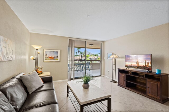 4200 N Miller Rd Unit 408, Scottsdale, AZ 85251 - living room featuring light tile patterned floors, floor to ceiling windows, and a textured wall