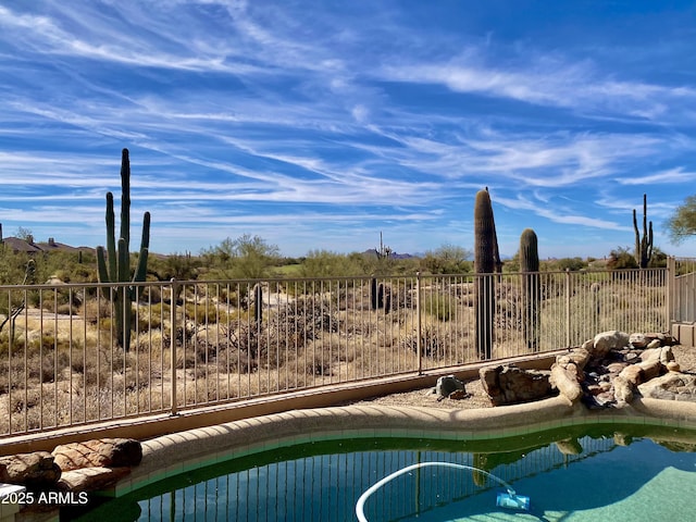 view of swimming pool featuring a fenced in pool and fence