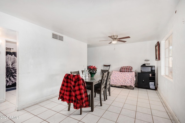 tiled dining room with ceiling fan