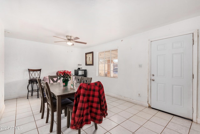 tiled dining space with ceiling fan