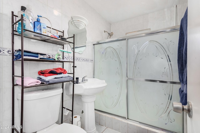 bathroom with toilet and tile walls