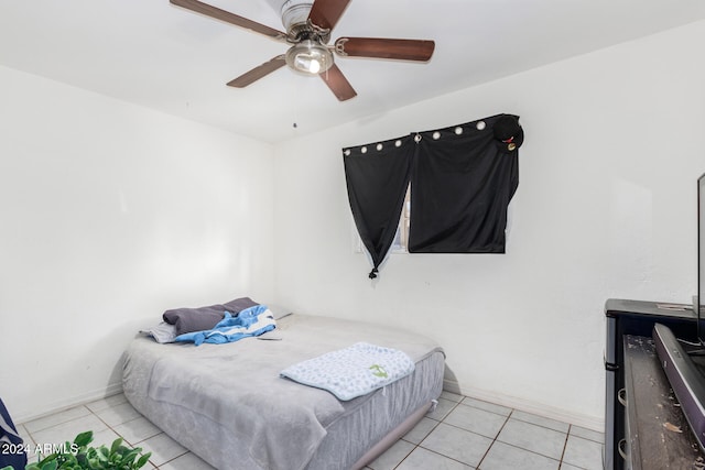 tiled bedroom featuring ceiling fan