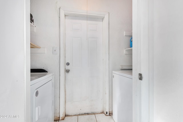 washroom with light tile patterned flooring and washing machine and dryer