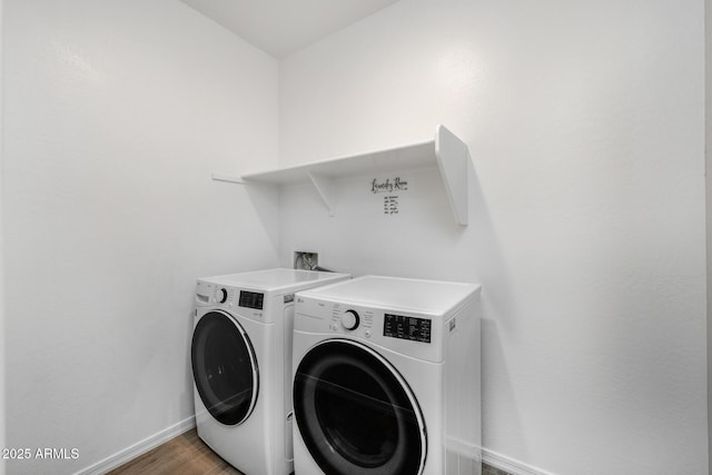 clothes washing area with dark hardwood / wood-style flooring and washer and dryer