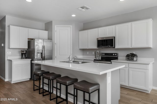 kitchen with white cabinetry, sink, and appliances with stainless steel finishes