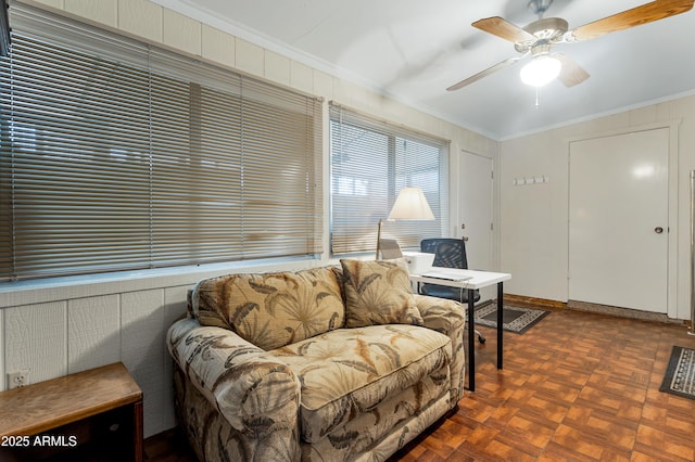 living room with ornamental molding, dark parquet flooring, and ceiling fan