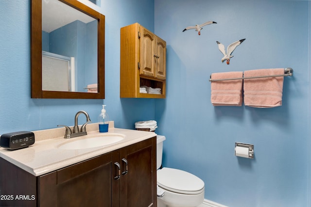 bathroom featuring toilet and vanity