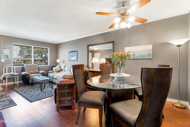 dining space with hardwood / wood-style flooring, ornamental molding, and ceiling fan