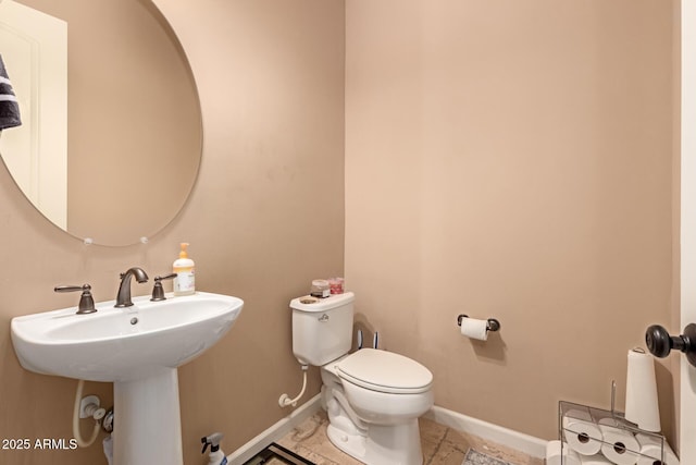 bathroom with tile patterned floors, toilet, and sink