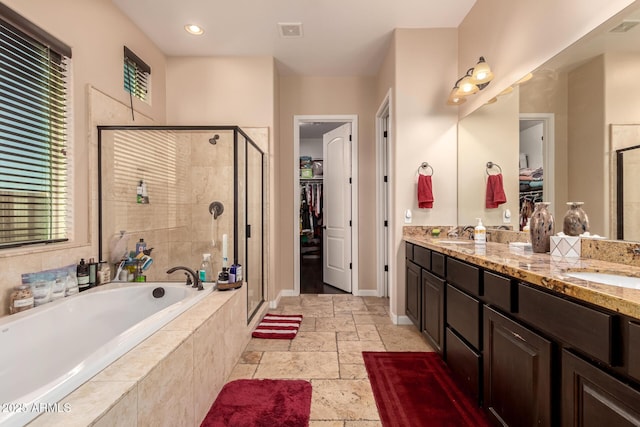 bathroom featuring separate shower and tub and vanity