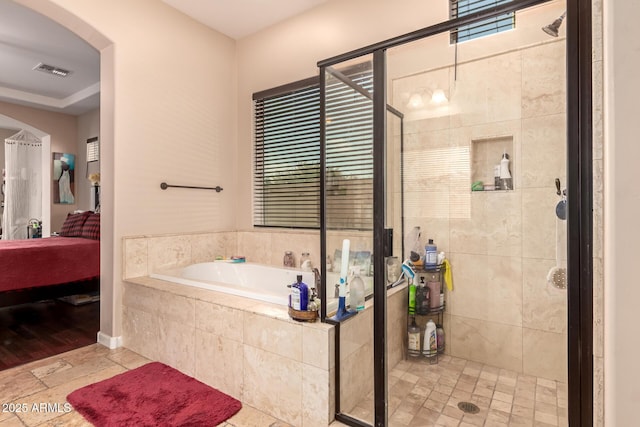 bathroom featuring separate shower and tub