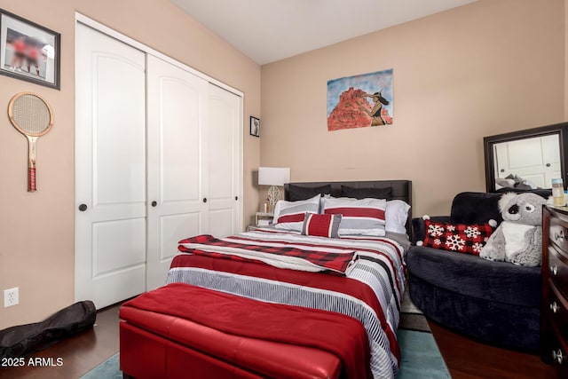 bedroom featuring wood-type flooring and a closet