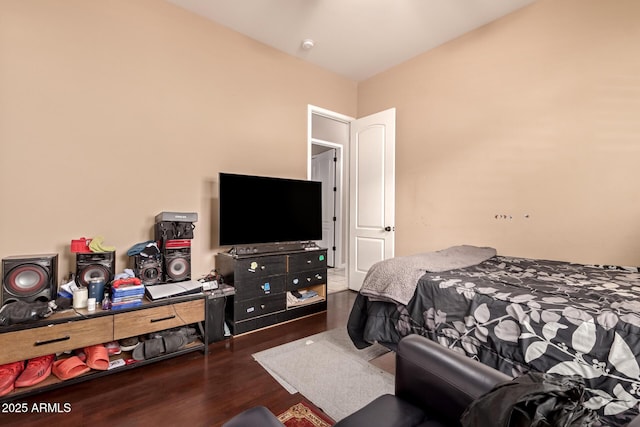 bedroom with dark hardwood / wood-style floors