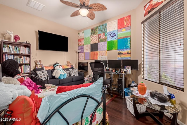 bedroom with dark hardwood / wood-style floors and ceiling fan