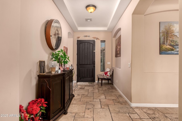 entryway with a raised ceiling