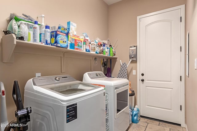 clothes washing area with washing machine and dryer