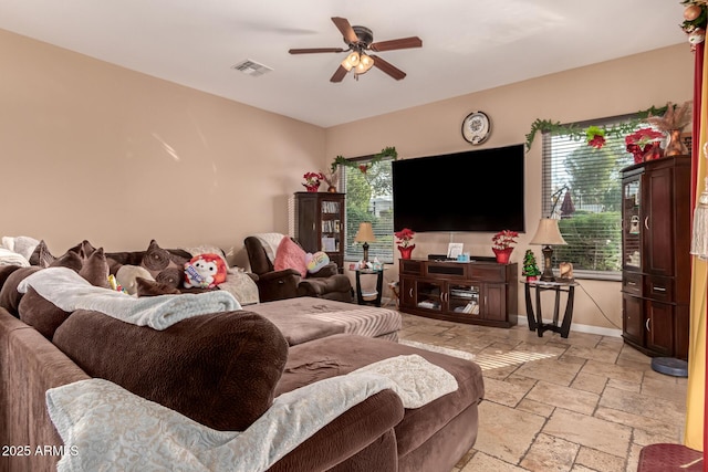 living room with ceiling fan and plenty of natural light