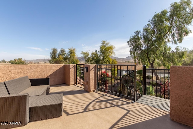 balcony featuring a mountain view and an outdoor living space