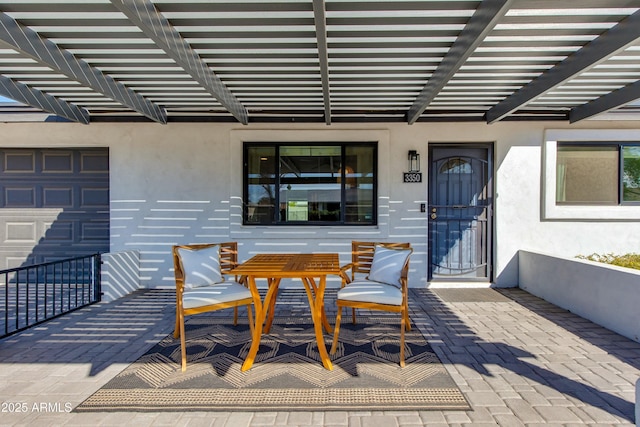 exterior space with a garage and a pergola