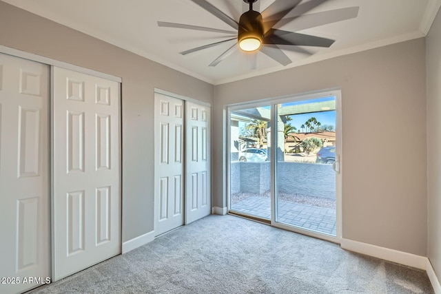 unfurnished bedroom with multiple closets, ceiling fan, light colored carpet, and access to exterior