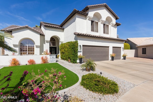 mediterranean / spanish-style home featuring a garage, fence, a tiled roof, driveway, and stucco siding