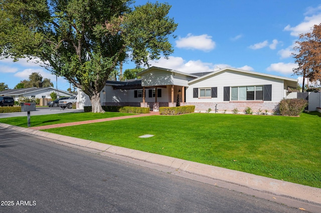 view of front of home with a carport and a front lawn