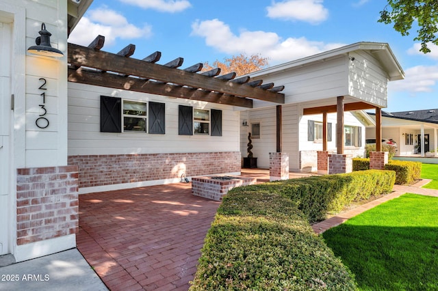 exterior space with a pergola and a lawn