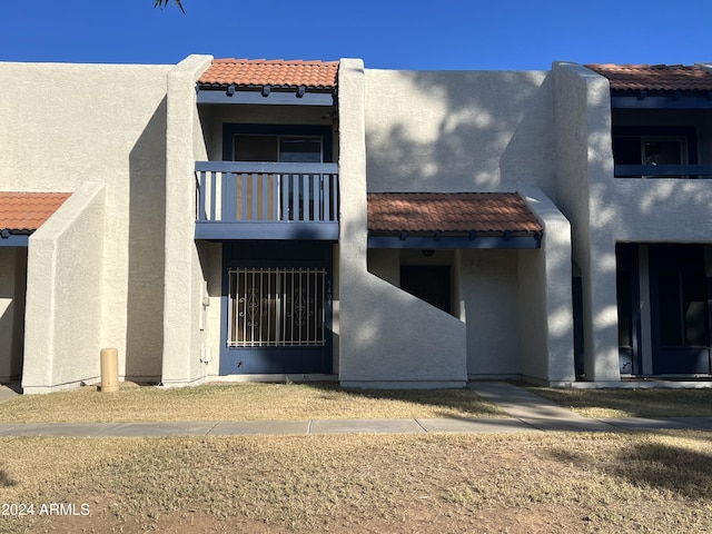 view of front of house featuring a balcony