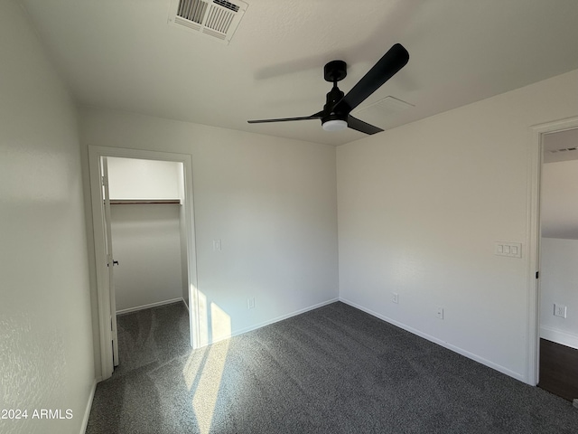 empty room featuring dark colored carpet and ceiling fan